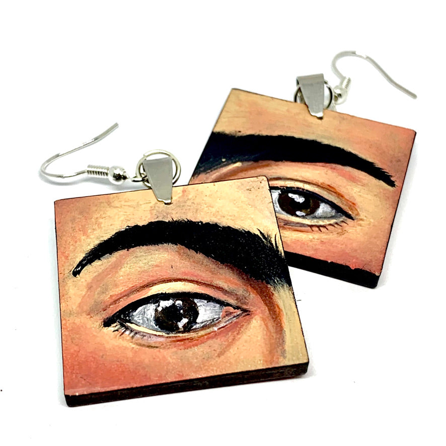 Hand painted Frida Kahlo fashion earrings. Square wooden earrings with Frida iconic eyebrows and expressive eyes. Great gift for fridamaniacs, fridalovers, fridamania, frida fans. Mexican earrings. Mexican jewelry.