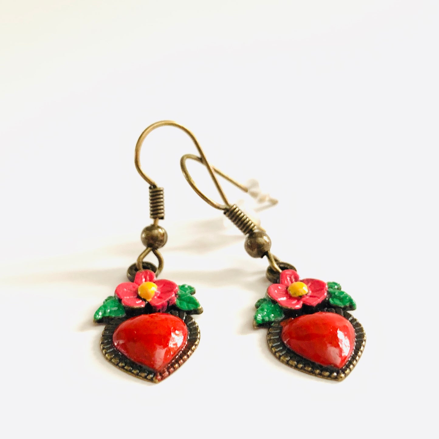 Bronze hand painted heart and flower earrings. Red, pink, green, and yellow paint. Mexican earrings. Mexican jewelry for fridamaniacs, fridalovers, fridamania. Frida Kahlo. Mother's Day gift.