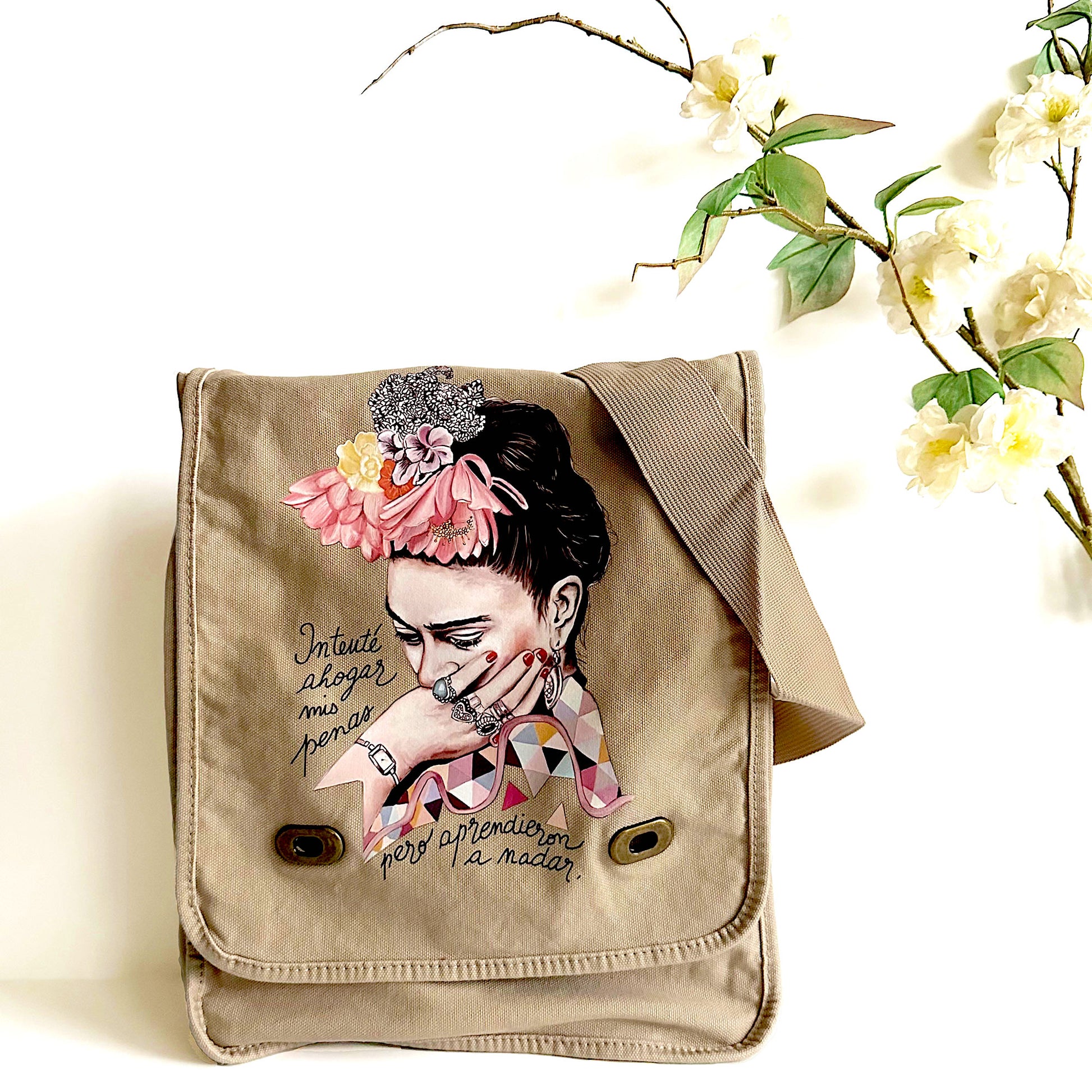 Frida Kahlo Bag: Shoulder or crossbody field bag, khaki color dyed washed soft cotton canvas fabric. Adjustable strap. Mexixcan artist floral illustration front sticker. Women and girls fashion accessory by Fridamaniacs