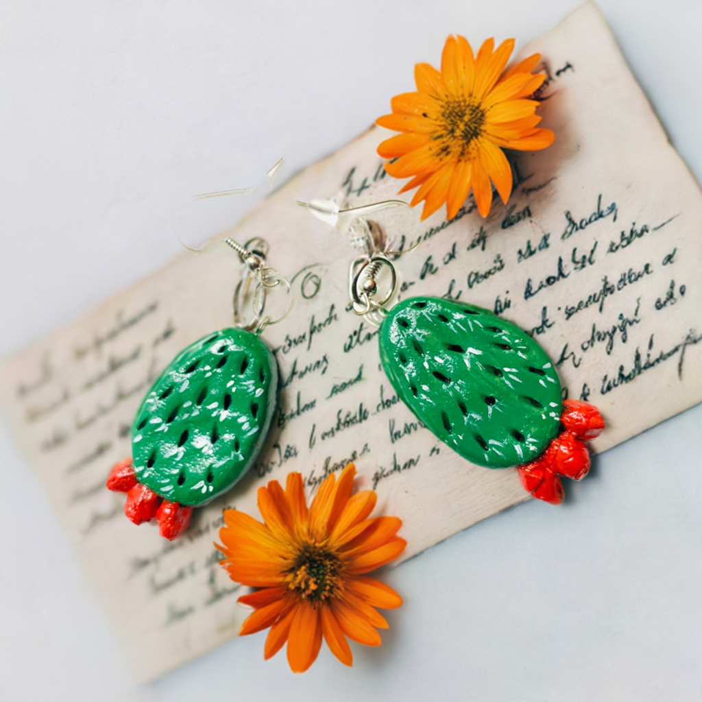 Artisan carved cactus clay earrings painted by hand by Mexican artisans. Fresh green cactus featuring vivid fire red desert cactus flowers. Mexican earrings. Mexico jewelry folk art. Frida Kahlo gift idea for women and girls. Mexicanias. Frida fans jewelry. Fridamaniacs. Fridalovers. Fridamania.