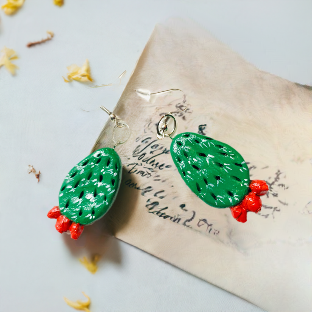 Artisan carved cactus clay earrings painted by hand by Mexican artisans. Fresh green cactus featuring vivid fire red desert cactus flowers. Mexican earrings. Mexico jewelry folk art. Frida Kahlo gift idea for women and girls. Mexicanias. Frida fans jewelry. Fridamaniacs. Fridalovers. Fridamania.