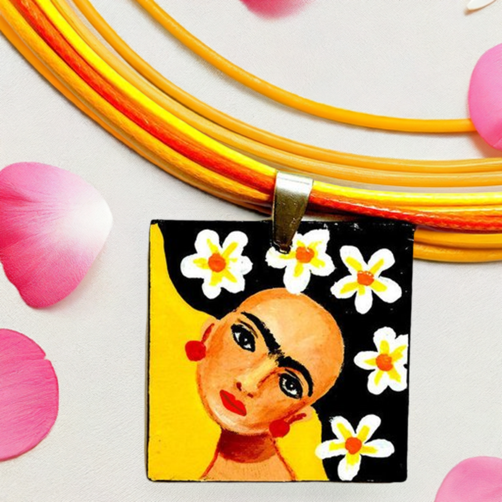 Vivid yellow hand painted Frida kahlo inspired square pendant with multicolored orange tones cords necklace. The painitng shows Frida Kahlo inspired face with iconic eyebrows and flowers. Fridamaniacs, fridalovers, and frida fans gift idea. Girl Mexican jewelry and necklace