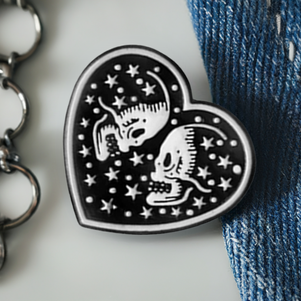 Black Heart with two white skull lovers and stars. Love to die for. Enamel pin back button by Calacamaia. Skull Jewelry accessory
