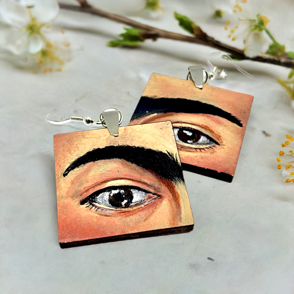 Hand painted Frida Kahlo fashion earrings. Square wooden earrings with Frida iconic eyebrows and expressive eyes. Great gift for fridamaniacs, fridalovers, fridamania, frida fans. Mexican earrings. Mexican jewelry.