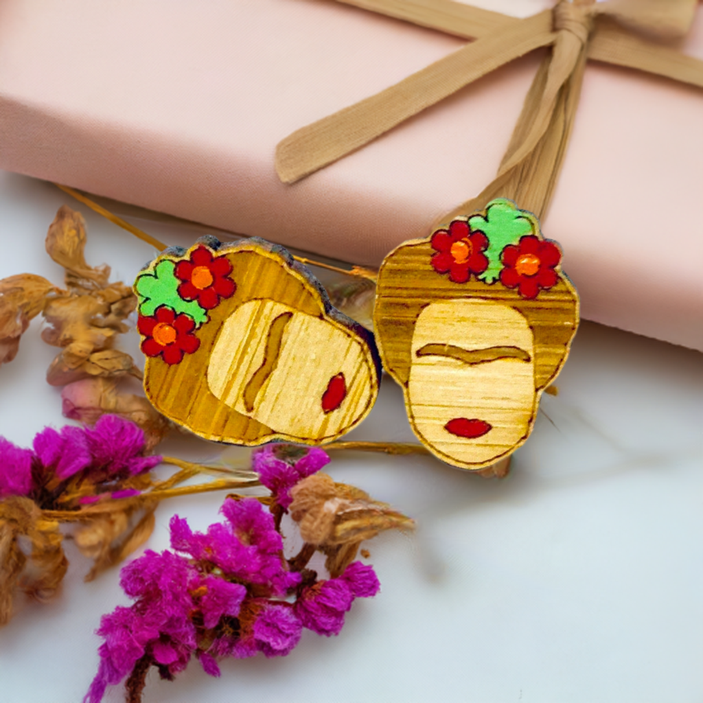 Floral Mini Bamboo Frida Kahlo inspired handpainted bamboo stud earrings with red flowers, green leaves, iconic eyebrows, and red lips for fridamaniacs, fridalovers, fridamania, frida fans girls. Cool gift idea. Mexican earrings. Mexican jewelry. Cute and original women jewelry accessories.