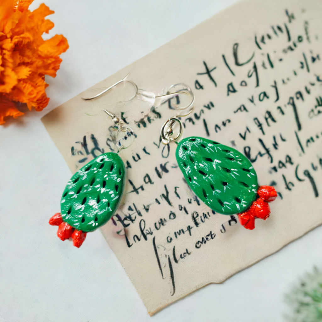 Artisan carved cactus clay earrings painted by hand by Mexican artisans. Fresh green cactus featuring vivid fire red desert cactus flowers. Mexican earrings. Mexico jewelry folk art. Frida Kahlo gift idea for women and girls. Mexicanias. Frida fans jewelry. Fridamaniacs. Fridalovers. Fridamania.