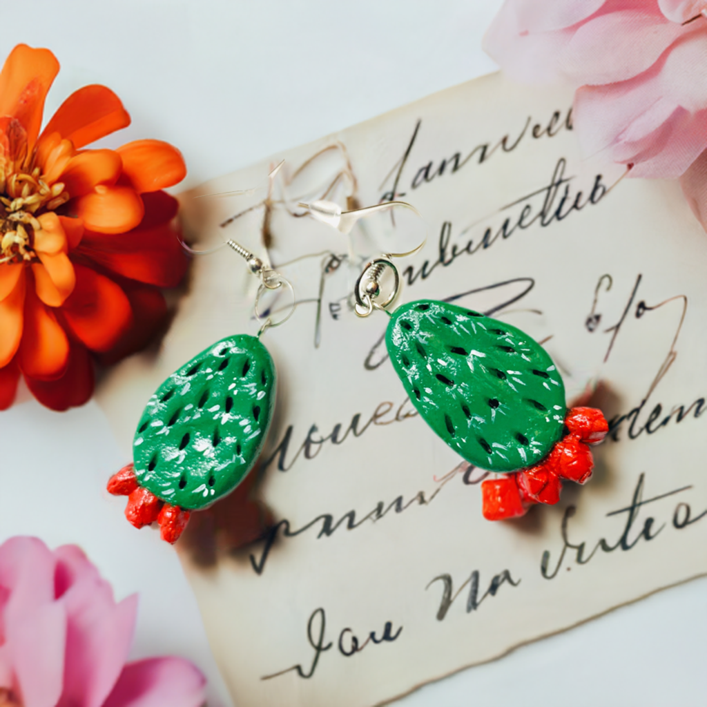 Artisan carved cactus clay earrings painted by hand by Mexican artisans. Fresh green cactus featuring vivid fire red desert cactus flowers. Mexican earrings. Mexico jewelry folk art. Frida Kahlo gift idea for women and girls. Mexicanias. Frida fans jewelry. Fridamaniacs. Fridalovers. Fridamania.