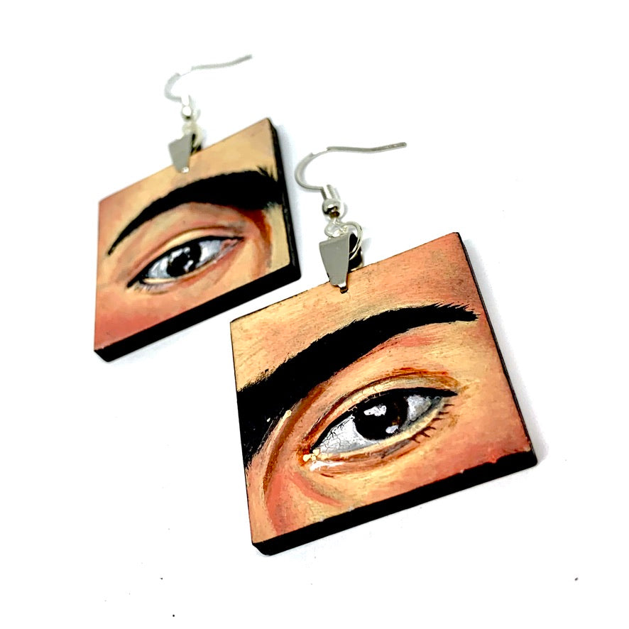 Hand painted Frida Kahlo fashion earrings. Square wooden earrings with Frida iconic eyebrows and expressive eyes. Great gift for fridamaniacs, fridalovers, fridamania, frida fans. Mexican earrings. Mexican jewelry.