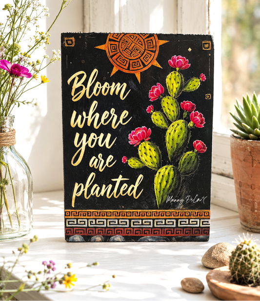 Decorative sign with cactus illustration and motivational quote in a home setting.
