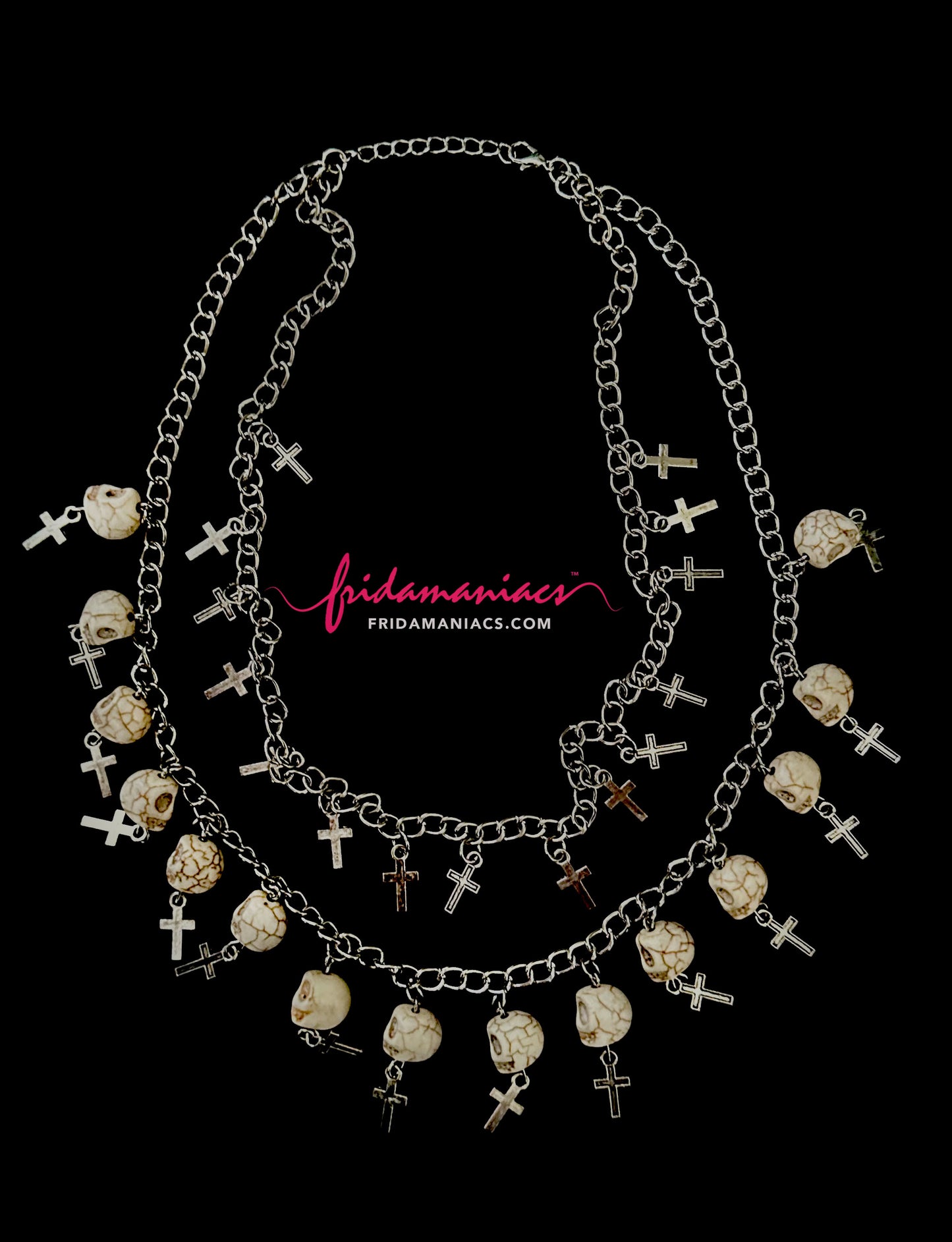 Necklace with skull and cross designs on a black background, featuring the brand 'Frida Maniacs'.