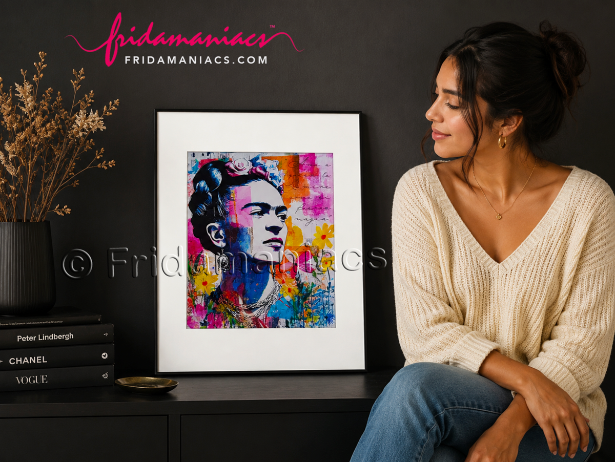 Woman sitting next to a colorful framed artwork with 'Fridamaniacs' branding.