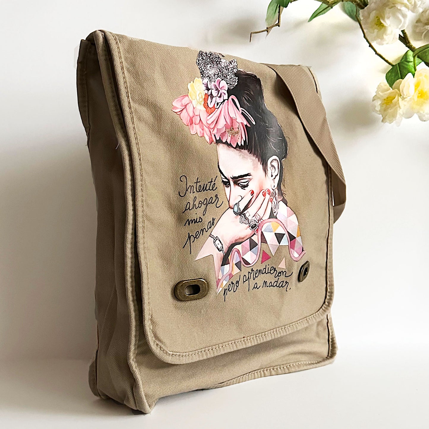 Frida Kahlo Bag: Shoulder or crossbody field bag, khaki color dyed washed soft cotton canvas fabric. Adjustable strap. Mexixcan artist floral illustration front sticker. Women and girls fashion accessory by Fridamaniacs