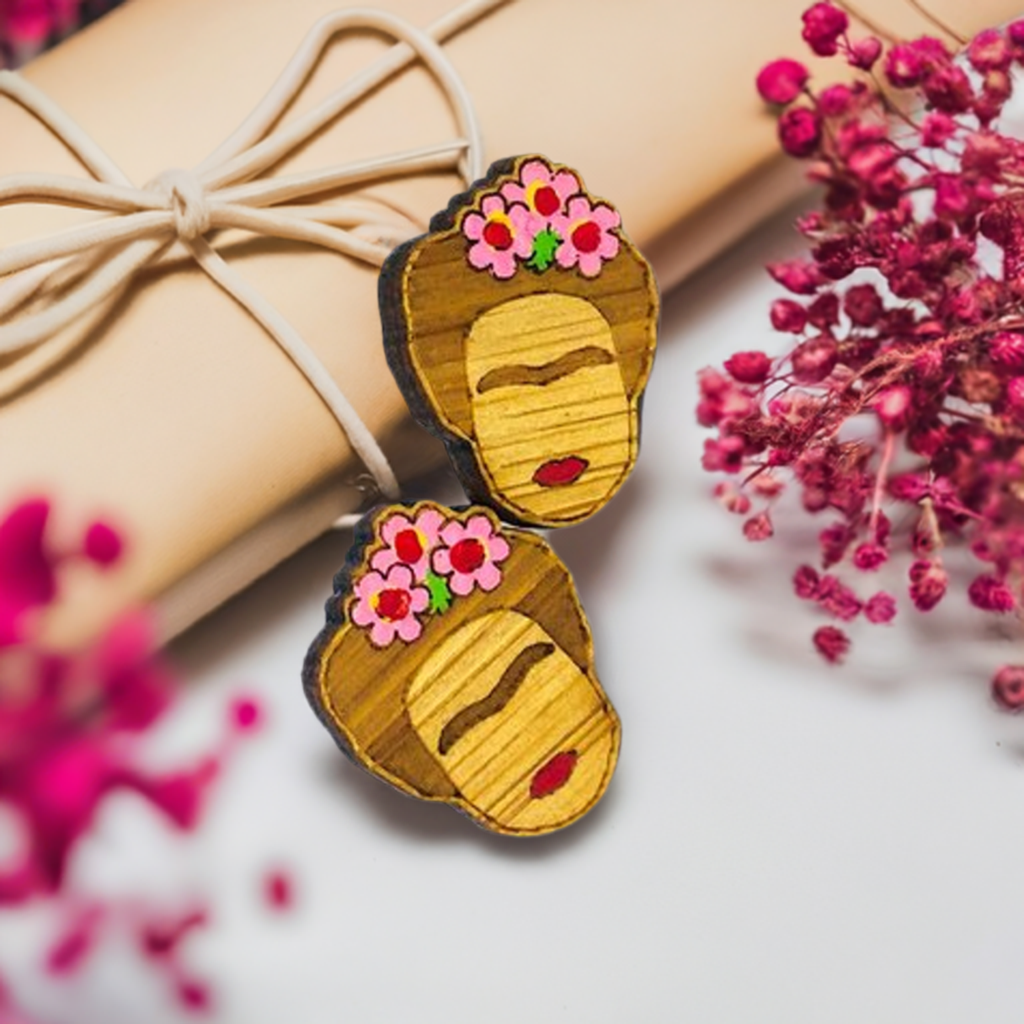 Hand painted Frida Kahlo mini bamboo stud earrings hanpainted with pink roses and red lips. Featuring iconic Mexican artist eyebrows. Mini face portrait. Cute gift idea for fridamaniacs, fridalovers, fridamania, frida fans. Mexican earrings. Mexican jewelry accessories.