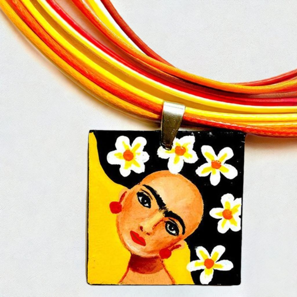 Vivid yellow hand painted Frida kahlo inspired square pendant with multicolored orange tones cords necklace. The painitng shows Frida Kahlo inspired face with iconic eyebrows and flowers. Fridamaniacs, fridalovers, and frida fans gift idea. Girl Mexican jewelry and necklace