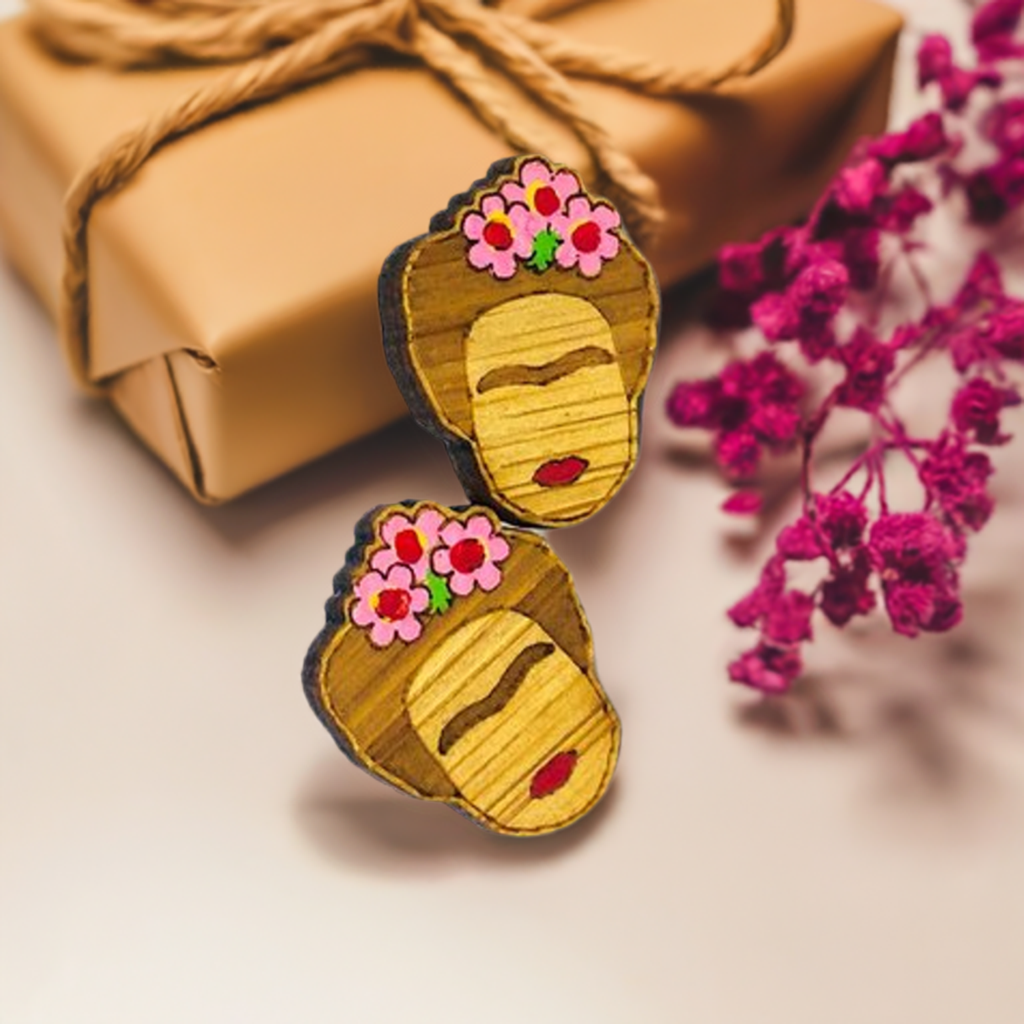 Hand painted Frida Kahlo mini bamboo stud earrings hanpainted with pink roses and red lips. Featuring iconic Mexican artist eyebrows. Mini face portrait. Cute gift idea for fridamaniacs, fridalovers, fridamania, frida fans. Mexican earrings. Mexican jewelry accessories.