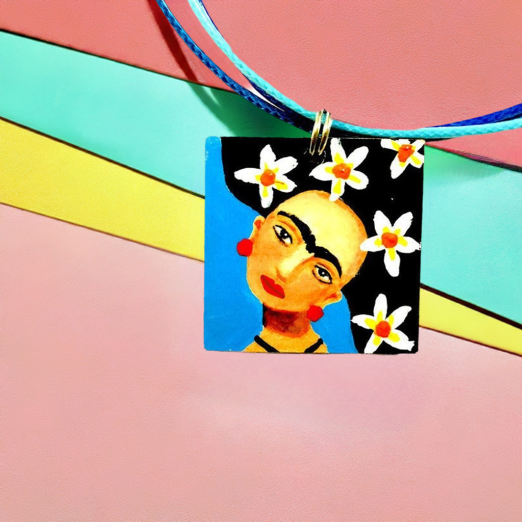 Hand painted Frida Kahlo inspired wooden square pendant with blue background, Mexican artist face with iconic eyebrows, and black hair with white flowers. Cute gift idea for girls. Fridamaniacs. Fridalovers. Mexican earrings. Mexican jewelry. Fridamania
