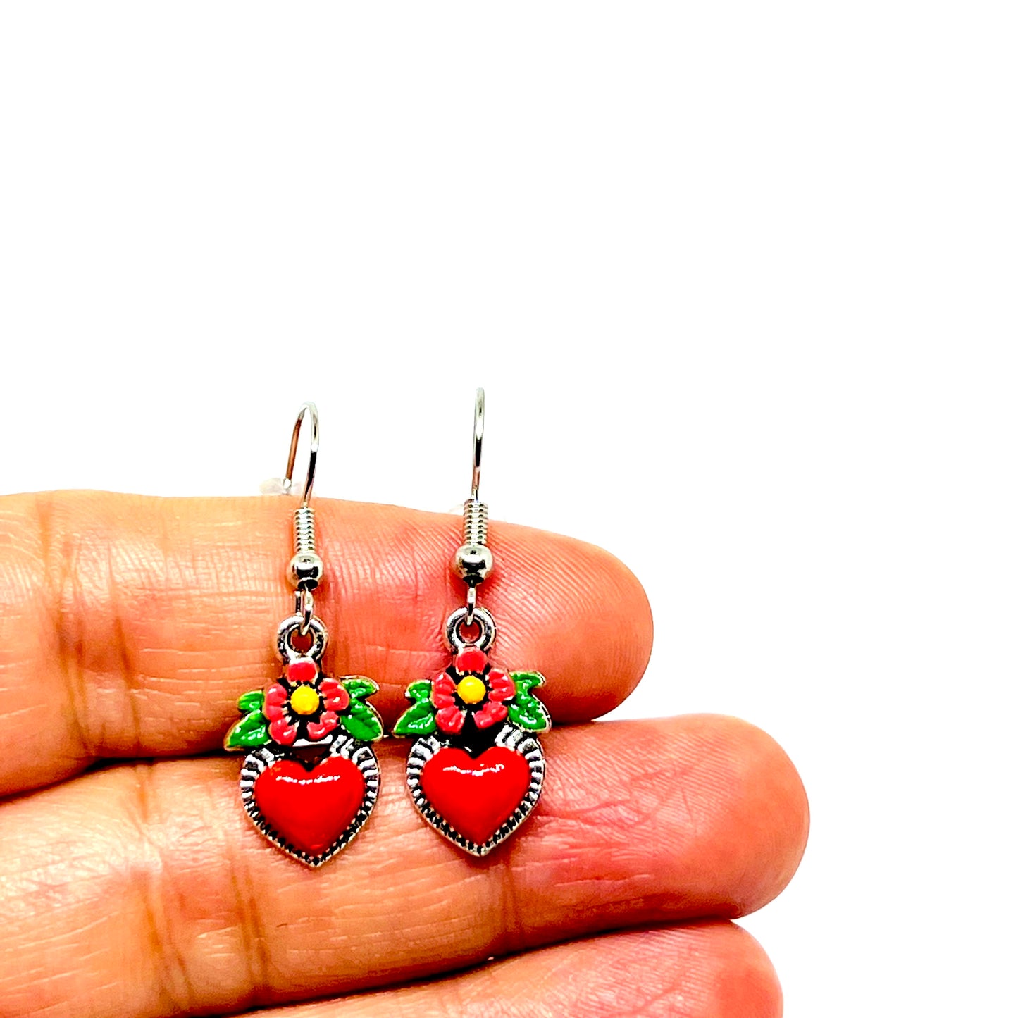 Hand painted heart and flower silver mexico earrings inspired by Frida Kahlo. Red heart, pinFlowered heart enamel earrings. Small red heart with pink flowers with yellow center and green leaves. Gorgeous Frida Kahlo inspired earrings. Mexican earrings. Mexican jewelry for girls and women. Drop and dangle.k yellow and green acrylic paint